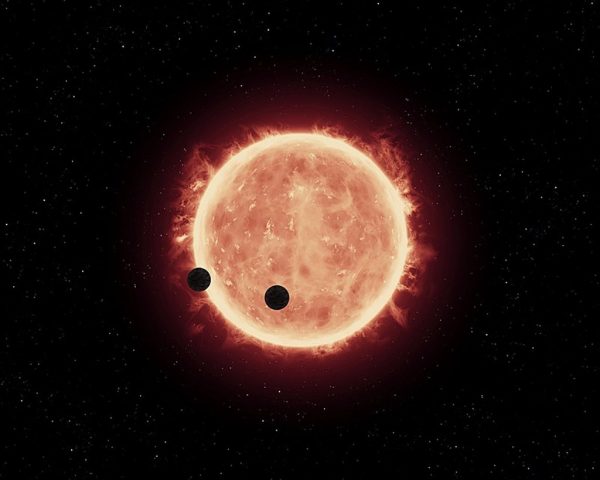 Artistic representation of TRAPPIST-1 planets transiting their host star. Image Credit: NASA, ESA, and G. Bacon (STScI)