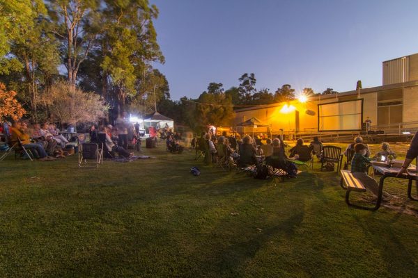 The audience enjoys picnics on the back lawn before Peter Birch’s lecture. Image credit: Geoff Scott