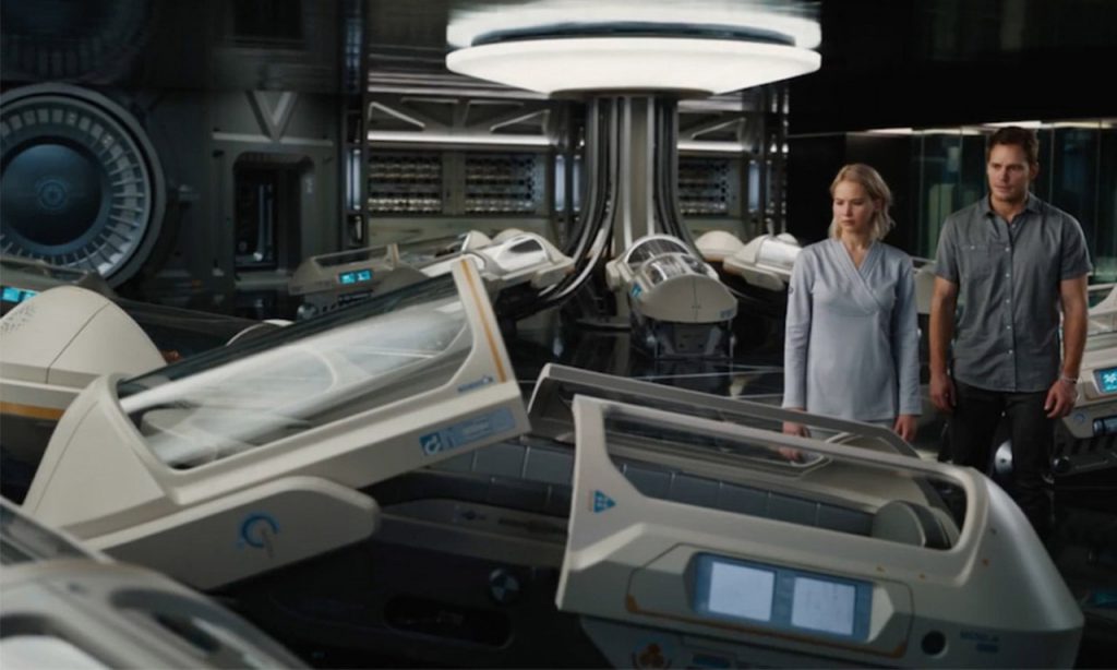 Aurora Lane (Jennifer Lawrence) and Jim Preston (Chris Pratt) next to sleeping pods. Image Credit: Columbia Pictures