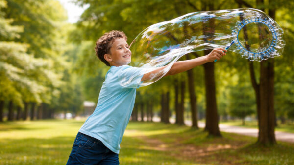 boy playing whit a big bubble