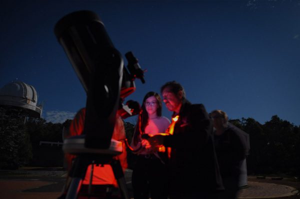 A workshop attendees taking photos with the CPC1100 telescope. Image Credit: Matt Woods