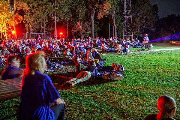 A spellbound crowd and Arthur presenting his talk. Image Credit: Geoff Scott