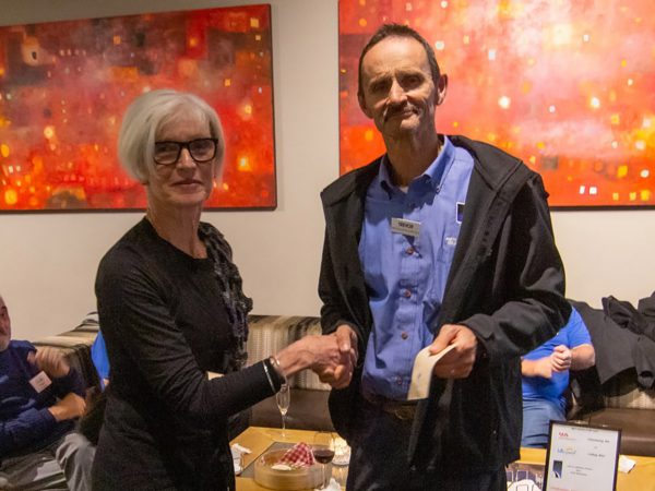 Diana handing volunteer Trevor his years of service badge. Image Credit: Geoff Scott