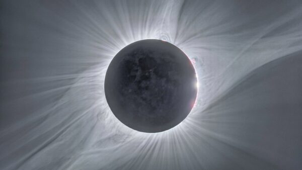 This image combines many exposures of different durations taken to reveal aspects of the widely-viewed total solar eclipse of 21 August 2017, which was visible from the United States. In the centre the faint circle of the Moon can be seen, with its surface features dimly illuminated in light reflected from the Earth. Around the edge red prominences can be seen and further out the white glow of the corona is sculpted by the Sun's magnetic field. Image Credit: ESO/P. Horálek/Solar Wind Sherpas project