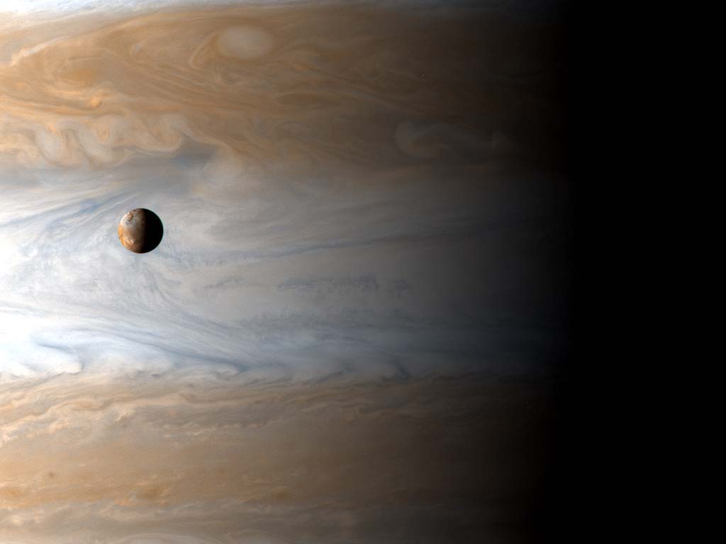 Jupiter and one of its moon Io. Image Credit: Cassini Imaging Team, SSI, JPL, ESA, NASA