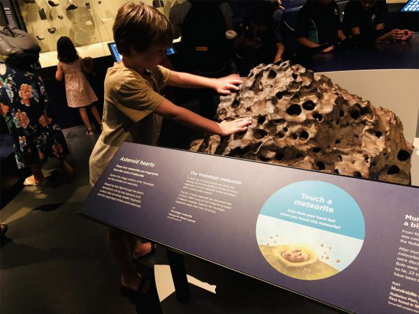 A kid with one of the large meteors at Boola Bardip. Image Credit: kids-around-perth.com