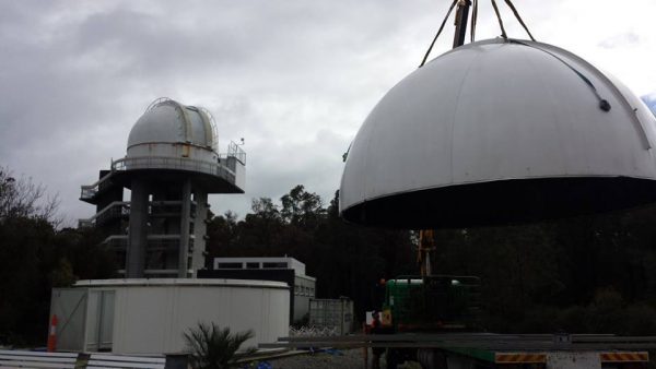 30 inch telescope dome roof being lifted onto the dome walls. Image Credit: Matt Woods
