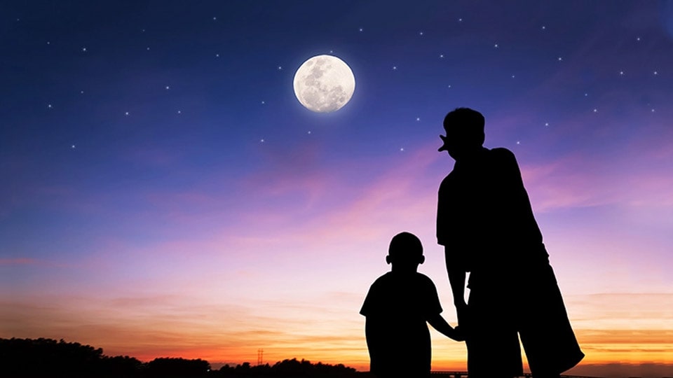 Father and son looking at the Moon