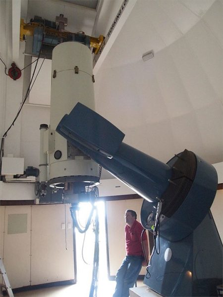 The Perth-Lowell Telescope with one of the people who automated it, Dr Andrew Williams. Image Credit: Matt Woods