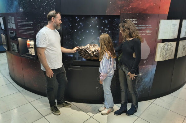 Attendees checking out a peice of the Mundrabilla Meteorite in our museum. Image Credit: Matt Woods