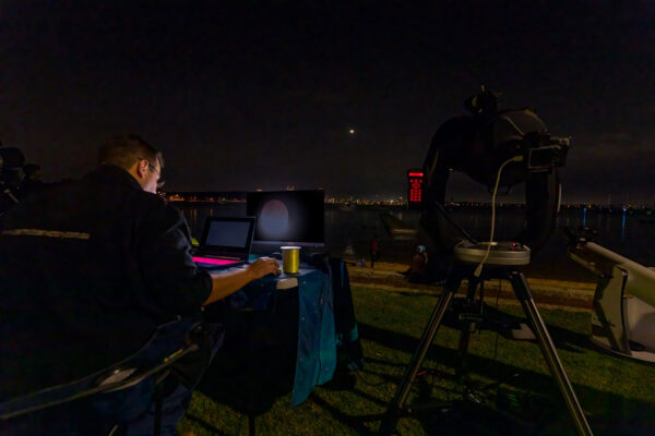 Photographing a total lunar eclipse. Image Credit: Micheal Goh