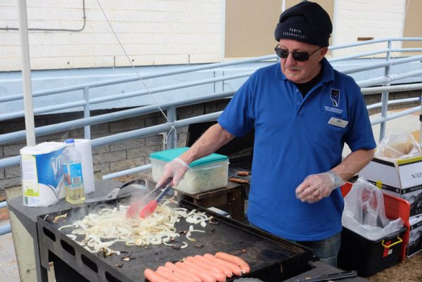 Volunteer Tad barbecuing. Image Credit: Geoff Scott